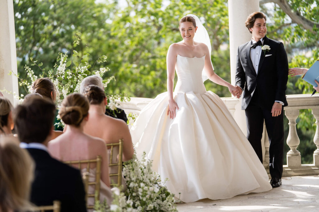 A happy couple on the terrace of Cliveden House on their wedding day